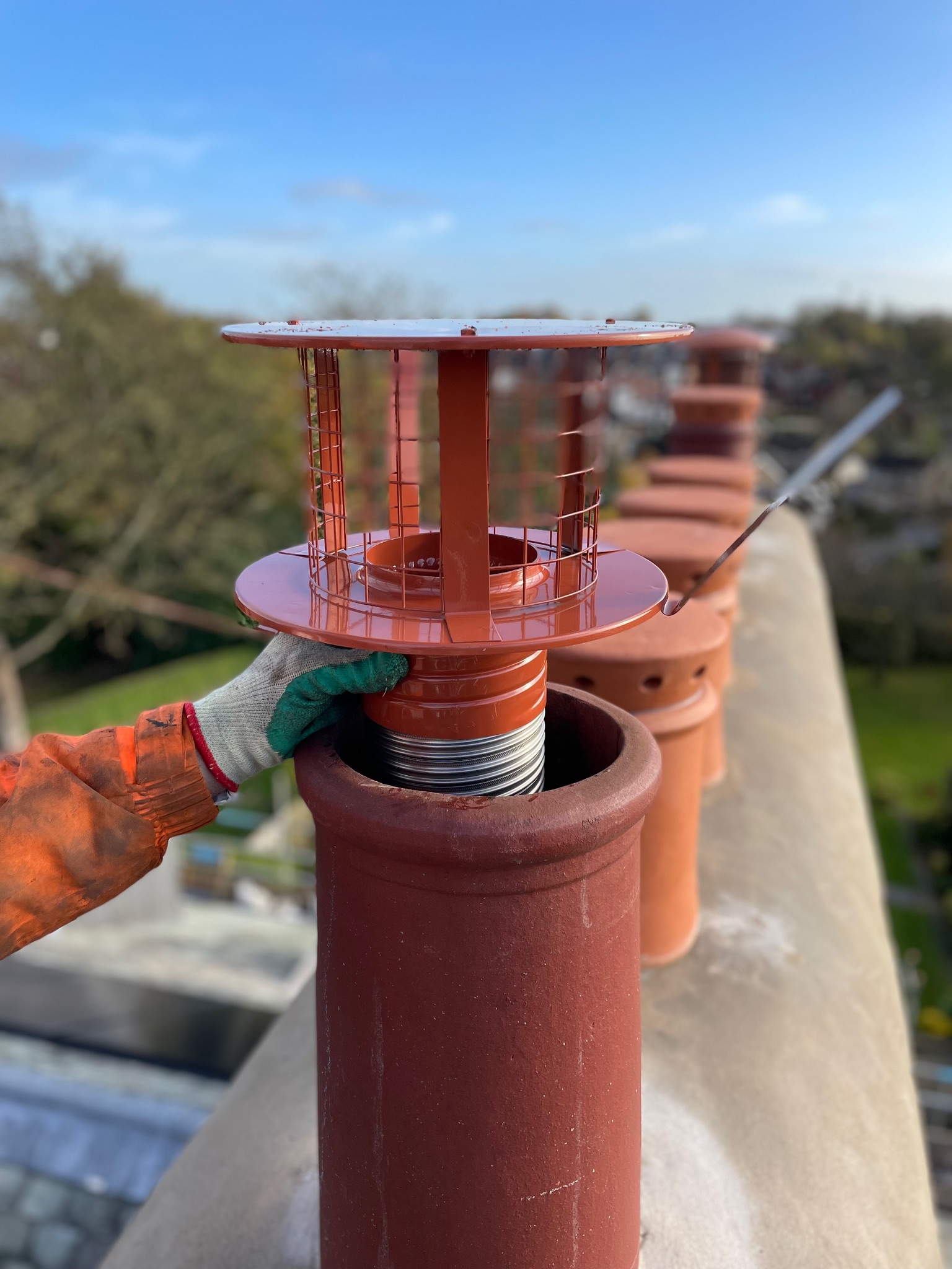 Chimney terminal installed above a pitched tiled roof